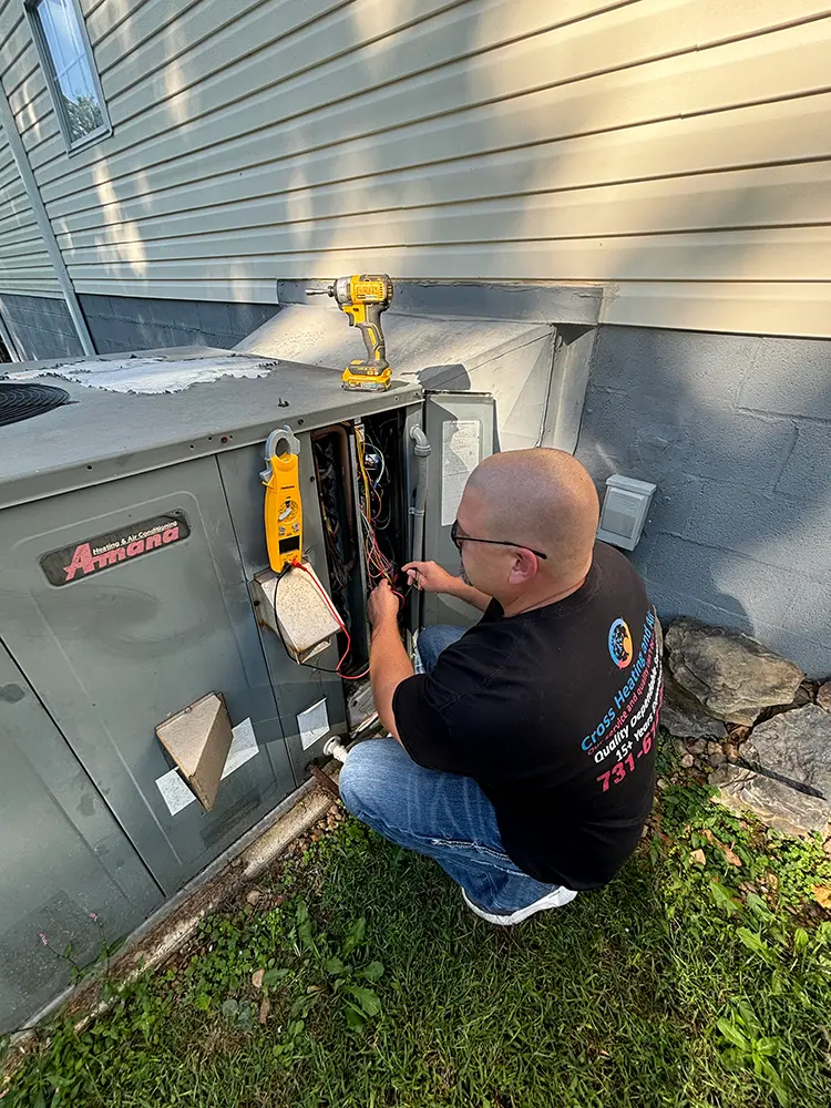 HVAC tech fixing a heat pump